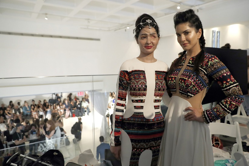 Model and acid attack victim Reshma Querishi, left, and actress Sunny Leone pose for photos backstage after modeling in the Archana Kochhar collection durin