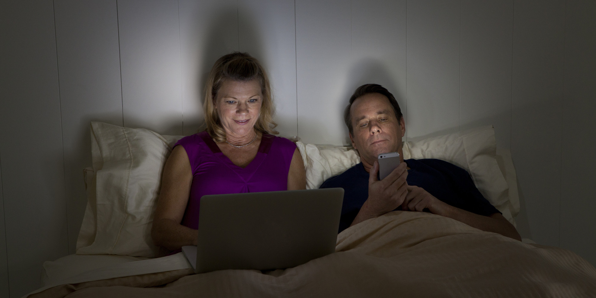 o-COUPLE-ON-PHONE-IN-BED-facebook