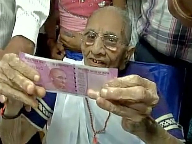 Modi's mother queues up at a bank to exchange cash