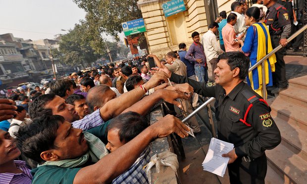 people queue up outside ATMs