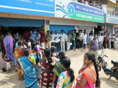 people queue up outside ATMs