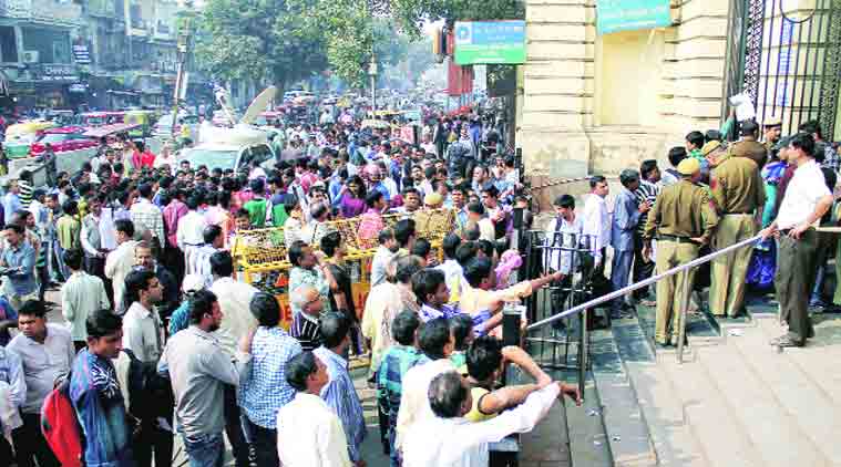 people queue up outside ATMs